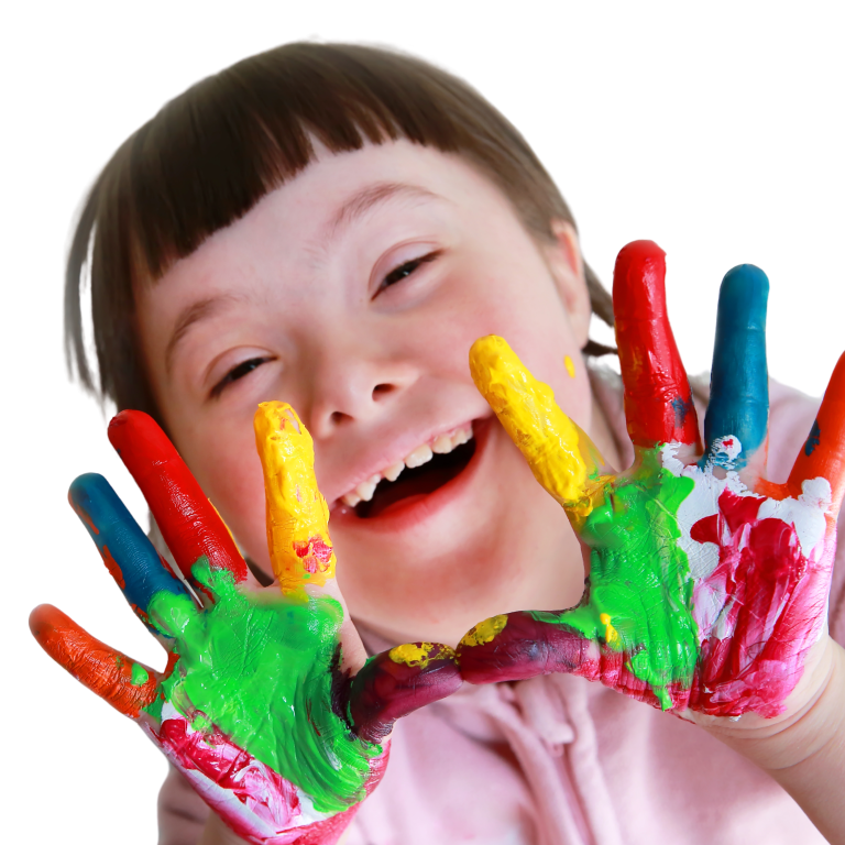 a smiling child raising hands that are covered in paint